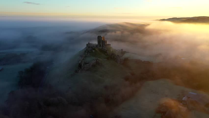 Corfe castle in the mist at sunrise - By drone