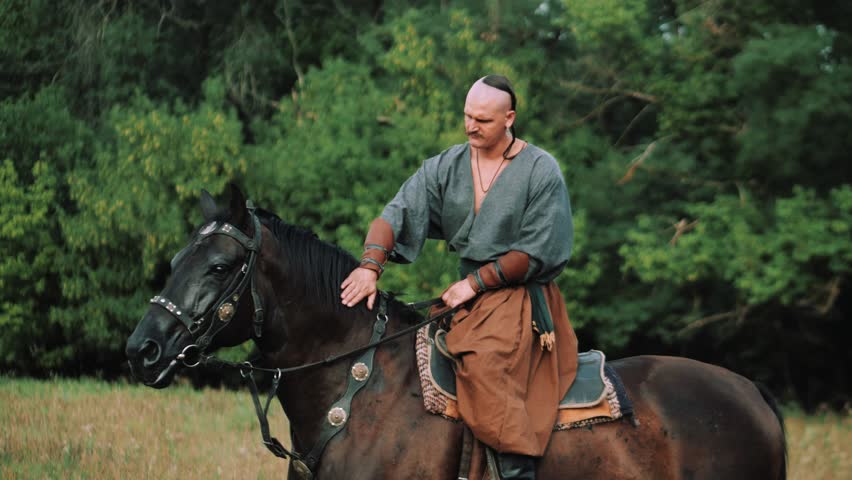 Ukrainian Cossack on horseback. Cossack in the Zaporozhian Sich. Strong people. Patriots of their country.