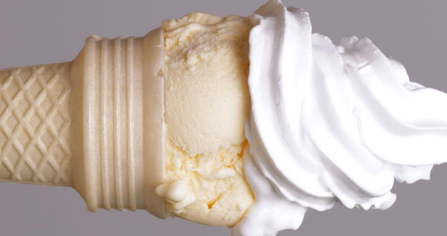 Vertical video 4K footage Front view CU, Move camera Squeeze white whipped cream over a vanilla ice cream cone on a gray background. | Shutterstock HD Video #1104244247