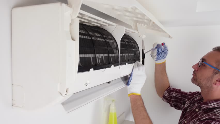 Service guy cleaning and maintaining air condition unit. Royalty-Free Stock Footage #1104247301