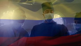 Animation of waving colombia flag against team of surgeons performing surgery at hospital. National medical healthcare technology concept - Powered by Shutterstock - Get 15% off with code: PIKWIZARD15