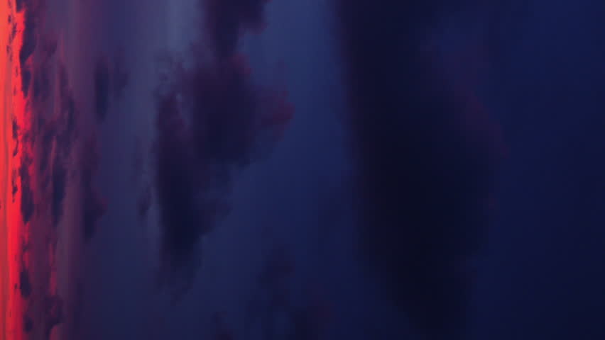 As day broke, the sky was filled with rosy tones, casting a captivating glow on the clouds above. Vertical video.