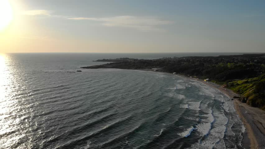 Aerial drone lateral motion footage morning sunrise over ocean. 4k