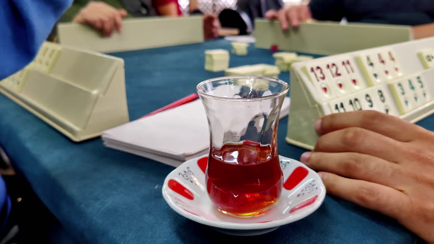 People Playing Okey Around The Table And A Cup Of Tea Footage. Royalty-Free Stock Footage #1104260479