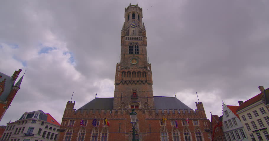 Brugge, Belgium establisher wide view. Time lapse medieval facades of houses. Clouds move in the background. Landmarks of Belgium architecture of Bruges. Protected monument of architecture