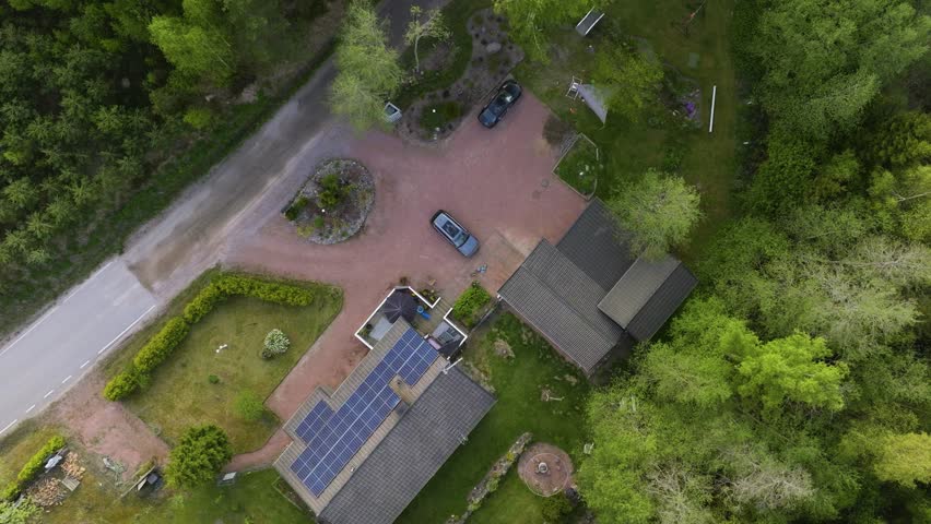 E-car charging on a detached house yard powered by sunlight collectors sunny, summer day