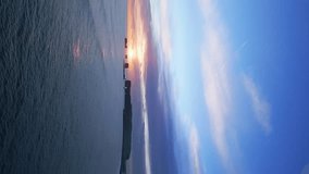 Vertical video: Arctic reynisfjara black sand beach on spectacular nordic landscape with sunset and ocean waves crashing on shore. Aerial view of icelandic coastline and natural scenery. 60 fps video. - Powered by Shutterstock - Get 15% off with code: PIKWIZARD15
