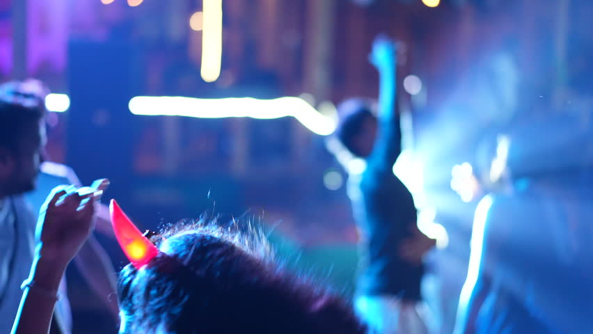 Wild girl dance night club. Woman wear devil horns halloween costume. Crazy man hang out rock rave. Happy people have fun. Evil hell party. Joyful guy rest halloween fest. Funky life. Drive crowd move