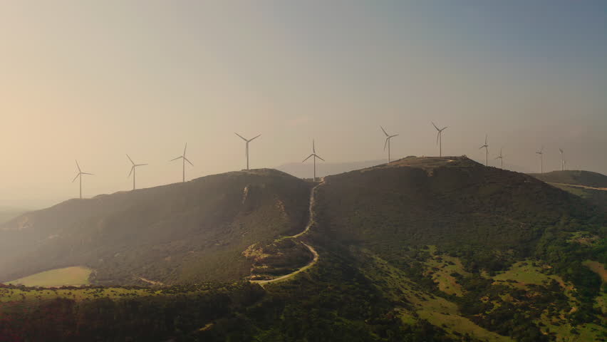 Windmills On Hills. Wind Spins Them Generate Electricity.
