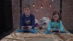 4K Happy siblings using joystick in bedroom