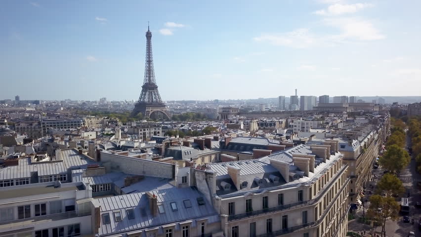 Aerial cinematic drone Paris France Eiffel Tower famous historic landmark from a distance mid day late summer romantic blue sky surrounded by buildings and car traffic backward motion Royalty-Free Stock Footage #1104274769