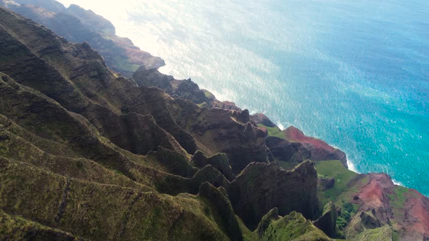 Cinematic aerial view of Napali Coast Kauai island Hawaii USA dramatic mountains, blue ocean drone flying over green jungle mountain peaks revealing tropical beach in Na Pali park.Tropical coastline | Shutterstock HD Video #1104277207