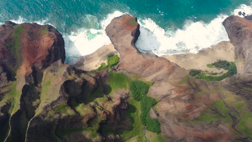 Breathtaking aerial view of Napali Coast Kauai green jungle dramaric mountain peaks, blue ocean, cliffs, white beach. Kauai island Hawaii USA Beautiful nature of Na Pali park. | Shutterstock HD Video #1104277381