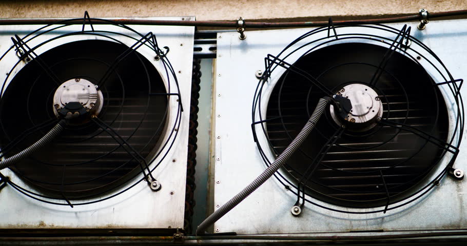 Air conditioner fans are spinning on the street wall. Close-up. Industrial air conditioners operate at full capacity. Special climate equipment, extreme heat. The fan blades are spinning. Split system Royalty-Free Stock Footage #1104278015