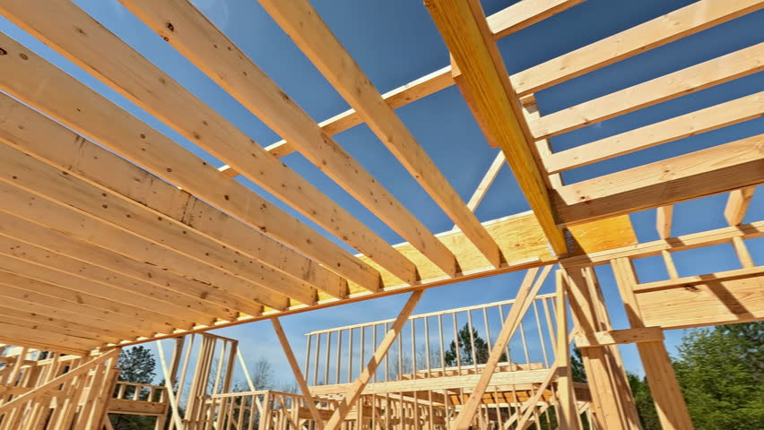 Building frame house made out of wooden beams stick framework for new construction