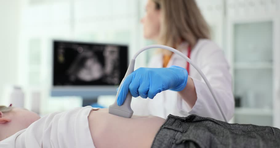 Doctor checks patient stomach with ultrasound equipment Royalty-Free Stock Footage #1104281177