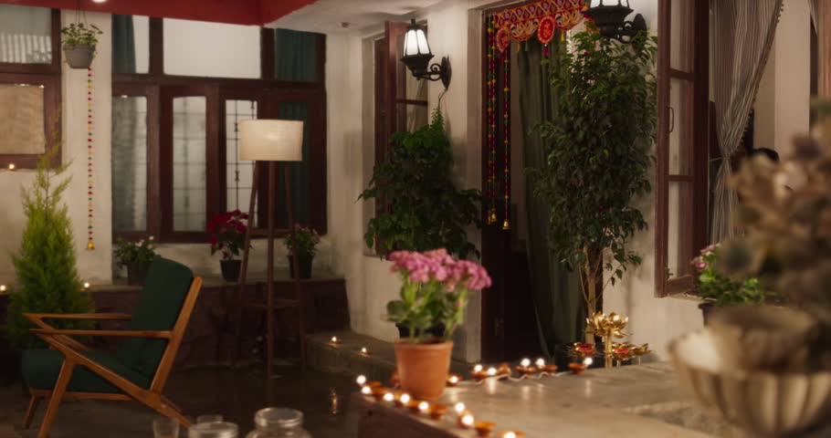Portrait of an Indian Family Celebrating Divali by Putting Lamps in Their Backyard. Happy Young Parents and Their Exited Children Participating in Hindu Religious Festivities, Festival of Lights