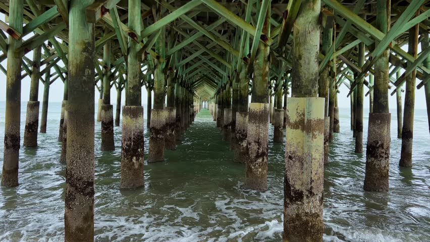 Ocean Waves crashing under the Apache Pier in Myrtle Beach South Carolina.
