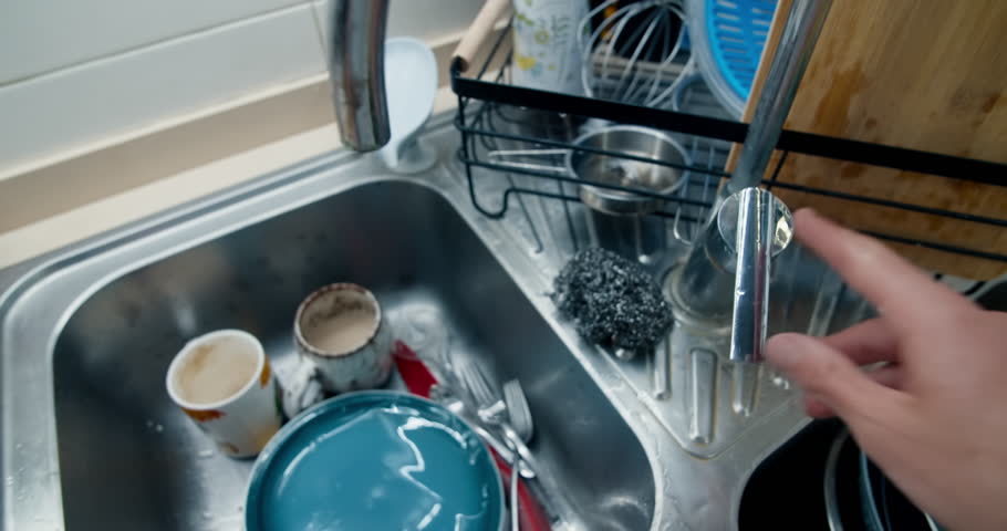 Man washing dirt dishes in kitchen first person perspective slow motion shot Royalty-Free Stock Footage #1104288281