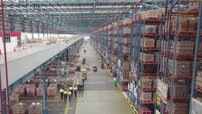 Delivery Warehouse full of shelves with goods in cardboard boxes, workers sort packages, move inventory with pallet trucks and Forklifts. Product Distribution Logistics Center. Asia. - Powered by Shutterstock - Get 15% off with code: PIKWIZARD15