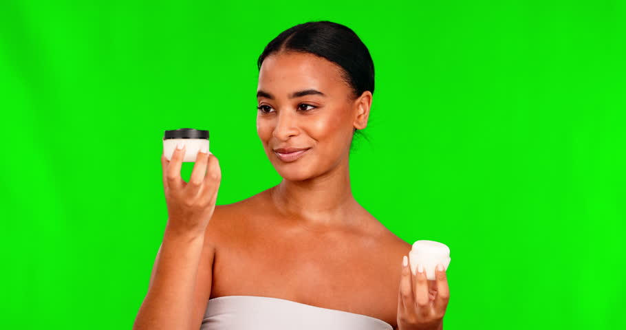 Portrait, skincare and lotion with a black woman on a green screen background in studio for beauty. Facial, cosmetics and cream with a happy young female model indoor to apply antiaging treatment Royalty-Free Stock Footage #1104290585