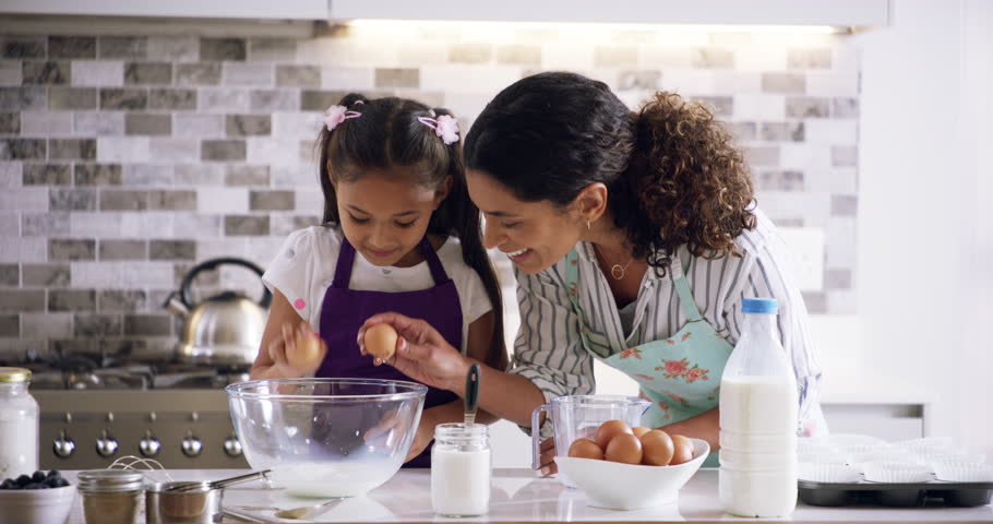 Baking, mom or learning girl in kitchen cooking cake, cookies or biscuits with parent at home. Teaching, kid or helping, milk or education as happy mother and daughter in a house to bake food Royalty-Free Stock Footage #1104290855
