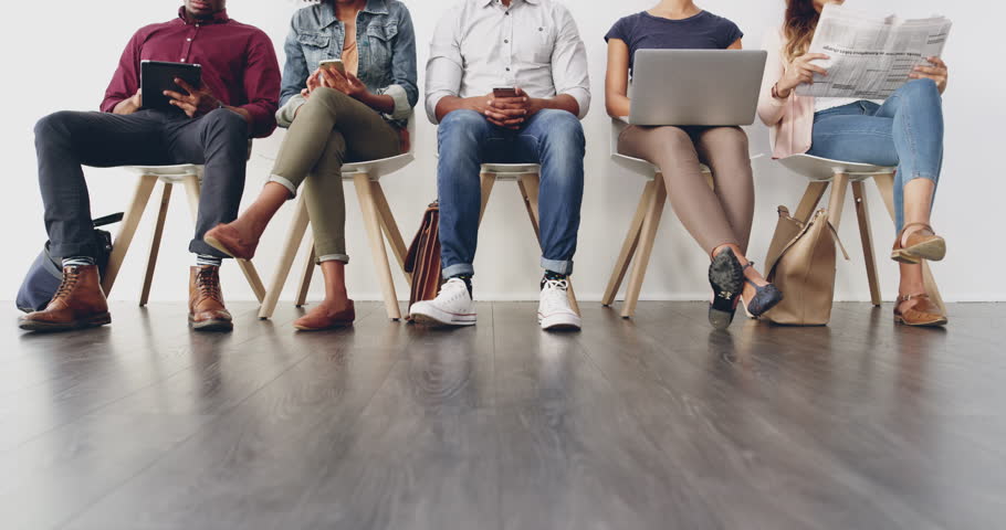 Technology, queue and closeup of people in a waiting room for a with human resources meeting in office. Recruitment, hiring and candidates sitting in a line or row for job interview in the workplace.
