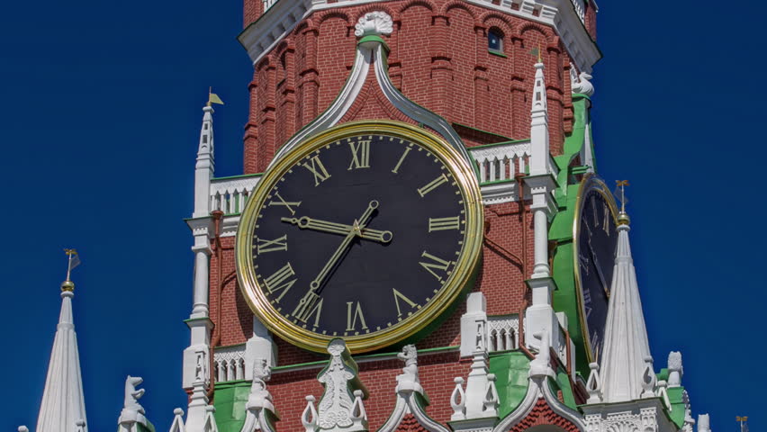 Moscow Kremlin on Red Square. Spasskaya Savior's clock tower timelapse hyperlapse decorated by the red ruby star on the top of it. Close up view. Blue sky background. UNESCO World Heritage Site. Royalty-Free Stock Footage #1104295795