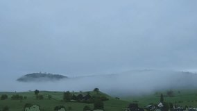 In this video, you will be transported to a mystical world of foggy landscapes and enchanting forests.

The video opens with a panoramic view of a serene landscape blanketed in a thick layer of fog. T