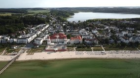 Aerial view, shot by a drone, showing the seaside resort and sandy beach of Binz with the historic spa house and hotel, located on the Ruegen Island in Germany