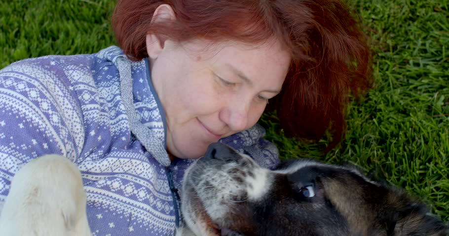 Woman hugs dog, kisses the pet head, touches wool with hands, rejoices at the meeting with the animal. Relaxation of psyche after work stress and emotional trauma. Providing canis therapy services. | Shutterstock HD Video #1104303641