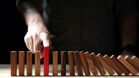 Management of Financial, Economic and Business Risk in Time of Crisis. The effect of business crisis on hand-stopping wooden dominoes. Risk, crisis, evaluation, insurance, safety, finances, economy - Powered by Shutterstock - Get 15% off with code: PIKWIZARD15