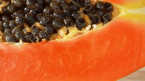 A captivating macro video showcases a half papaya, revealing intricate details through a probe lens. Rich colors and textures mesmerize viewers. Macro dolly shot. Shot with laowa 24mm probe lens
