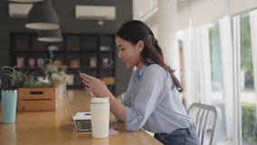 Adult female worker asia people happy smile sit easy relax work hybrid at share office enjoy play typing chat look at mobile phone buy or paying SME retail loan, post read news review app AI chatbot. - Powered by Shutterstock - Get 15% off with code: PIKWIZARD15