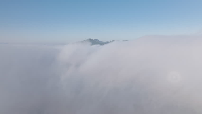 Cloud time lapse nature background 4K aerial. Drone flying through fluffy white clouds in clear blue sky. White cloud cloudscape, summer blue sky time lapse. Nature weather blue sky background Royalty-Free Stock Footage #1104312545