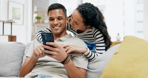 Couple, sofa and hug with smartphone search for video, movie and meme with happiness in home living room. Man, woman and phone with love, relax and house for social network app, internet and blog