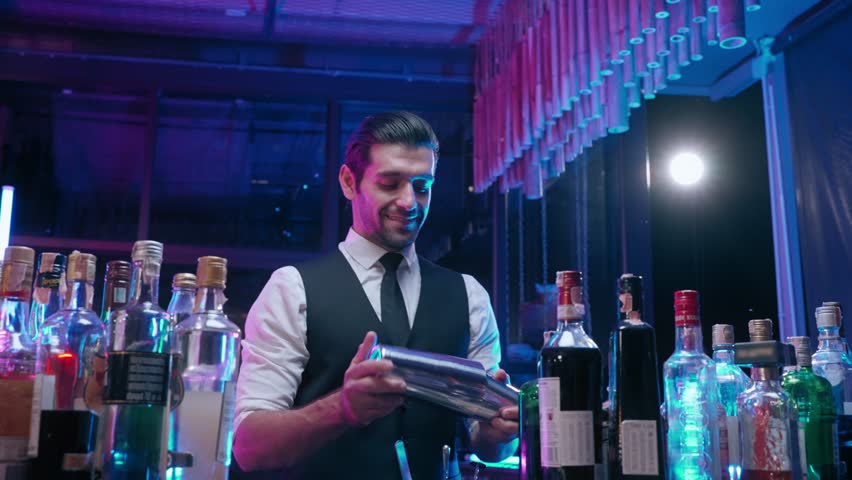 Professional bartender man shaking cocktail for guest in nightclub Royalty-Free Stock Footage #1104320851