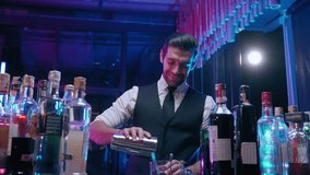 Professional bartender man shaking cocktail for guest in nightclub - Powered by Shutterstock - Get 15% off with code: PIKWIZARD15