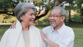 Asian senior man embrace with blanket to wife in the garden, Love and care concept - Powered by Shutterstock - Get 15% off with code: PIKWIZARD15