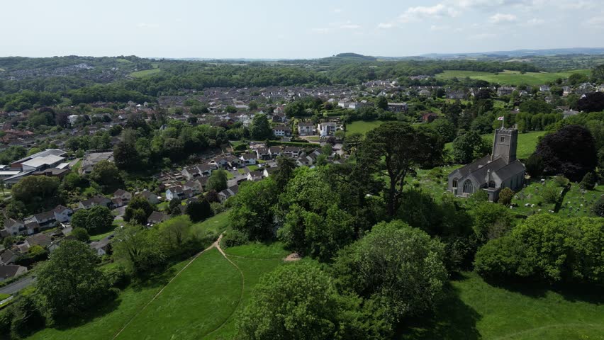 Highweek, Newton Abbot, Devon, England: DRONE AERIAL VIEWS: The drone shows All Saints Church in the foreground with Highweek village in the background. Dartmoor National Park is in the distance.