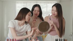 Group of friend, Young adult Asian females with beautiful healthy skin, sharing skincare and cosmetic experiences at home, and exchanging beauty insights. Beauty routine
