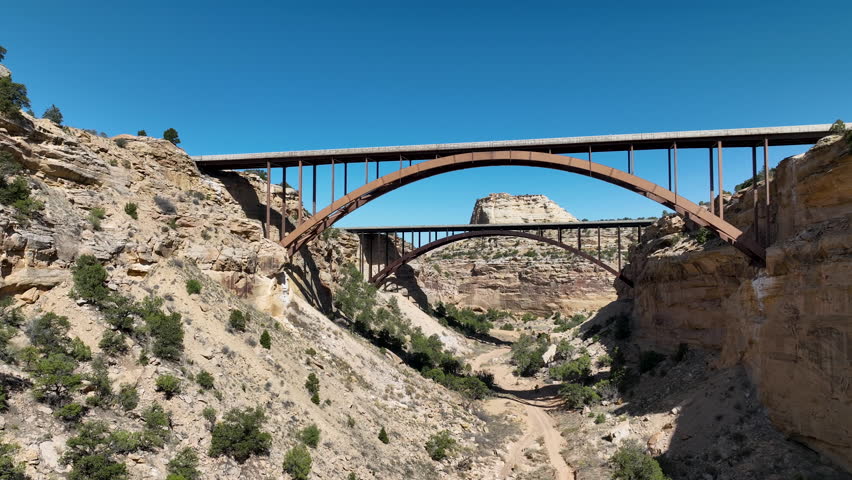 Aerial Eagle Canyon highway bridge fly under Utah fast . San Rafael Reef geologic landscape central Utah. Eroded into tall fins, domes, cliffs, and deep canyons. wilderness desert environment.