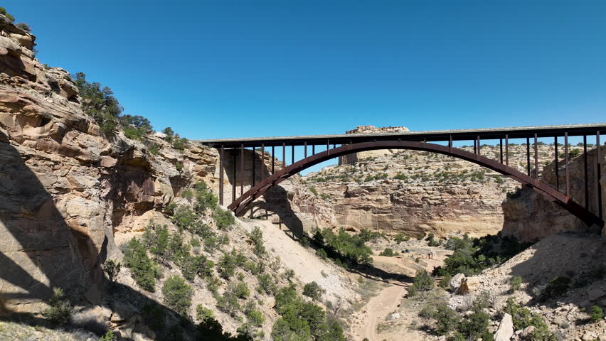 Aerial Eagle Canyon highway bridge fly under Utah 2. San Rafael Reef geologic landscape central Utah. Eroded into tall fins, domes, cliffs, and deep canyons. wilderness desert environment.