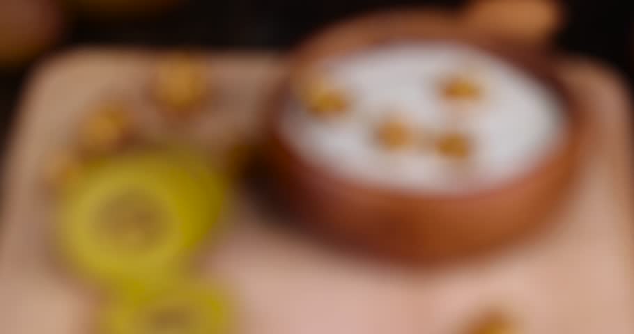 Focus on fresh yogurt with kiwi flavor and with pieces of fruit and popcorn, delicious fresh yogurt with the addition of pieces of ripe yellow kiwi and popcorn | Shutterstock HD Video #1104324221