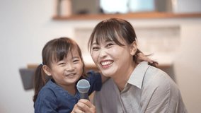 Parents and children enjoying karaoke at home
