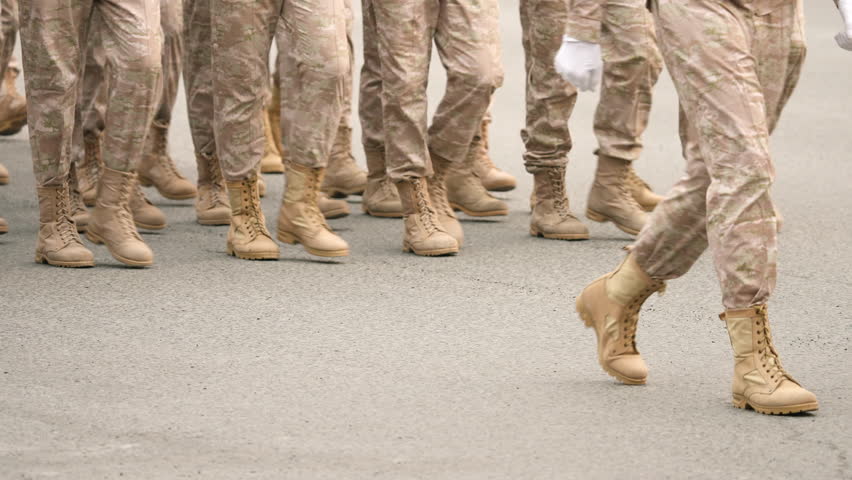 Military boots close up. Lot armed soldier walk slow motion. Male war team. Army platoon step. Many officers march. Men combat troop. Hot spot fight. Nation military forces. Sand desert shoe uniform. Royalty-Free Stock Footage #1104327989
