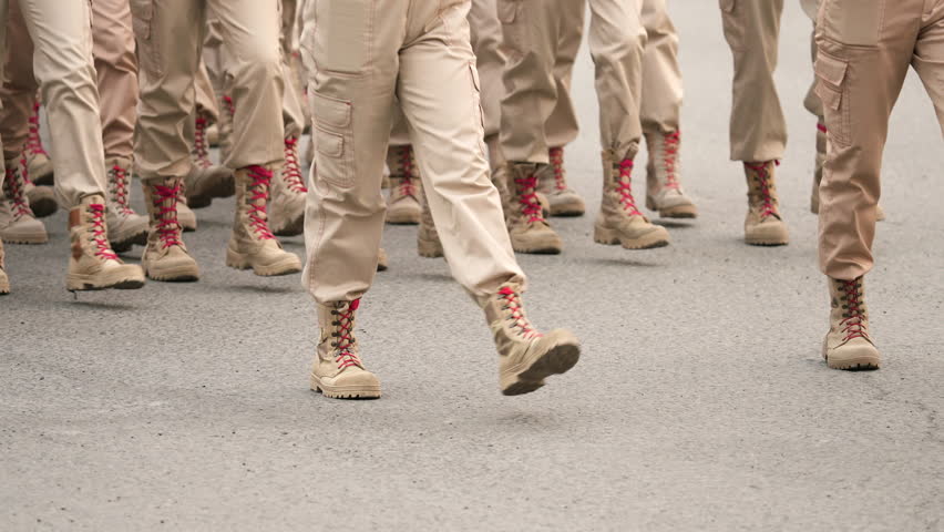 Military suede boots close up. 9 may victory parade. Red shoe laces. Male army soldiers. War hot spot. Lot young man walk. Beige boot pair step slow motion. Sand desert uniform. Yunarmy troop march. | Shutterstock HD Video #1104328039