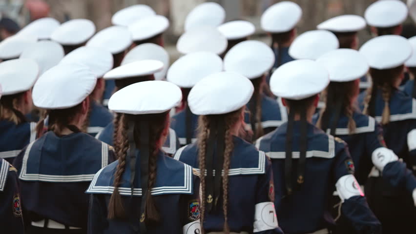 Lot young sailors man marching. Naval military forces. 9 may war victory parade. Marine troop army. Navy soldier stepping close up. Blue sea suit uniform. Sailor cadets walk slow motion. Kid seal team