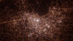 Lafayette (Louisiana, USA) aerial view at night. Top view on modern city with street lights. Camera is zooming out, rotating clockwise. Vertical video. The north is on the left side