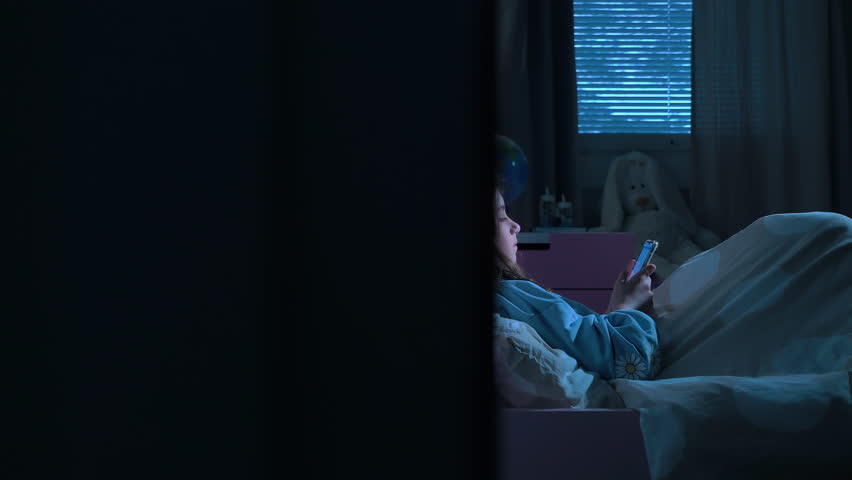 Teen girl lying in bed at night using smartphone, scrolling social media and texting. Not healthy sleep. Insomnia and the harm of the smartphone before going to bed. Dependence on social networks Royalty-Free Stock Footage #1104340275